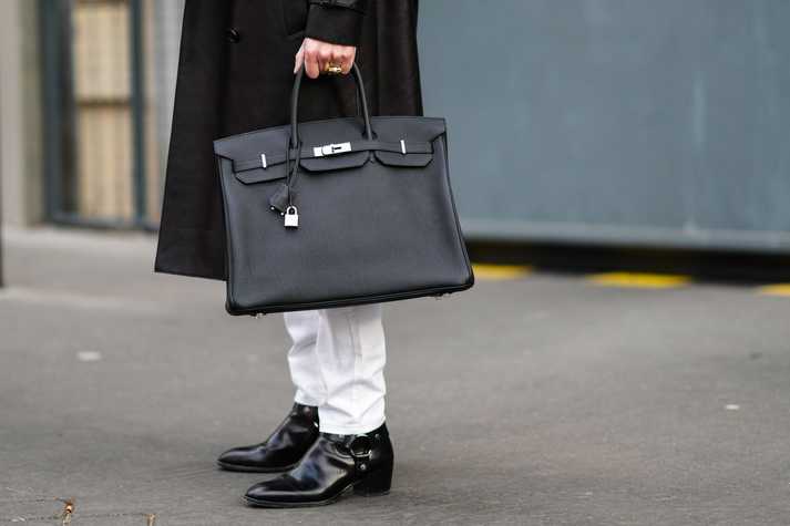 A man holding a Hermès Birkin Bag during Paris Fashion Week